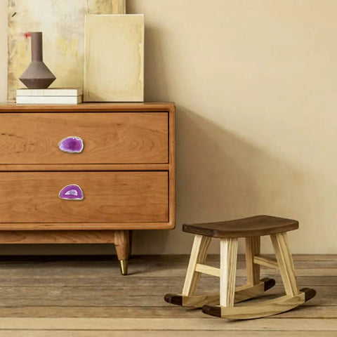 Pack Of Four Rose Red Agate Slice Drawer Knobs With Gold Plated Edges For Kitchen Cabinets on a wooden dresser.