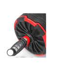 Multifunctional Modular Ab Roller And Core Builder With Tire Tread Anti Skid Wheels showing cushioned black and red handle and tire tread design.