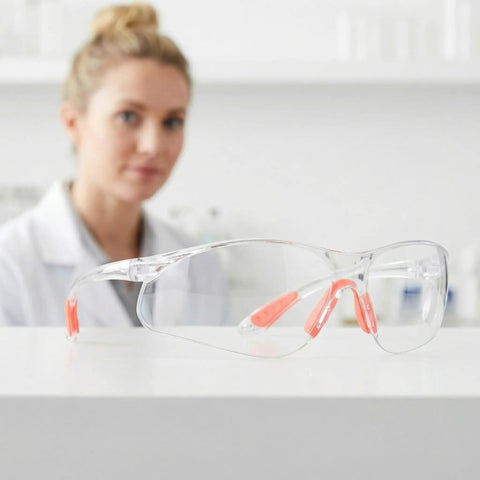 Badass Silicone Safety Glasses For Construction Work, shatterproof polycarbonate lenses with silicone straps on a table.