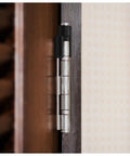 Zero Footprint Carbon Steel Door Hinge Guard With Quick Tool Free Install Fits All Standard Residential Doors Stops Kickbacks Dead In Tracks While Keeping Walls Totally Snag Free, close-up on a hinge