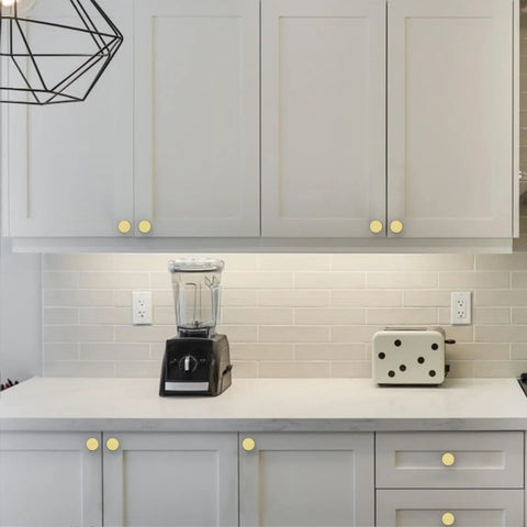Thirty Piece Set of Slick Brushed Gold Cabinet Knobs With Knurled Textured Grip Heavy Duty Kitchen and Cabinet Hardware Perfect For Drawers and Cupboards Boasting No Sweat Installation and a Durable Corrosion Resistant Finish Looking Dang Good on kitchen cabinets.