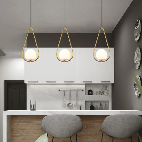 Gold Brass Modern Pendant Light For Kitchen Island With Glass Globe, One Light Indoor Hanging Fixture in contemporary kitchen setting