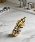 Real Deal 130156 Shower Valve Cartridge Replacement Featuring Heavy Duty 3 4 Inch Brass Core displayed on marble surface.