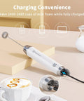 Rechargeable Milk Frother With 3 Heads, USB C Handheld Foam Maker, Waterproof Detachable Stainless Steel Whisk, Stand Included, Electric Drink Mixer For Lattes And Cappuccinos, Rich Foam Anytime shown charging with USB cable on kitchen counter.