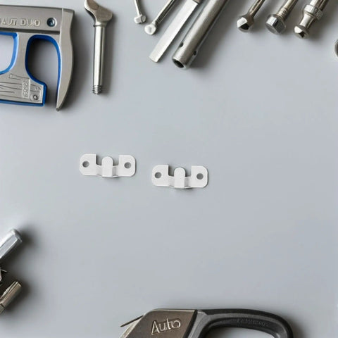 Heavy Duty Stainless Steel French Cleat Picture Frame Brackets 8 Pack With Mounting Screws placed among tools on a gray surface.