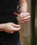 Person holding a Heavy Duty Copper Ball Valve 6 Pack Built Tough NPT Thread connector with red handle for easy shut off.