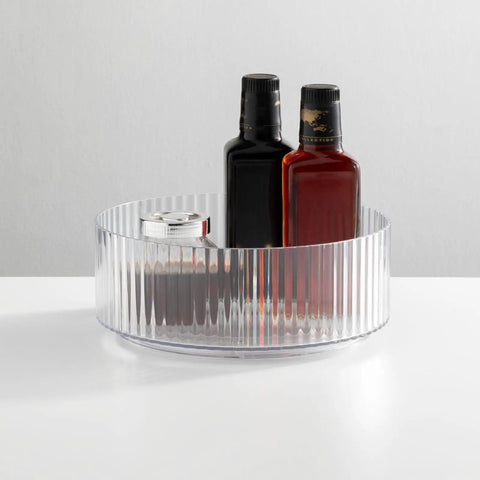 Two Pack Fluted Lazy Susan Plastic Spinner Turntable For Kitchen Counter Organizing Rotating Organizer Swivel Tray For Spices And Accessories 9 Inch Round Clear Sturdy Build with bottles inside.