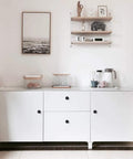 White cabinet with Ten Pack Matte Black Round Cabinet Knobs For Cabinets, Drawers, Cupboards, Solid Zinc Alloy, One And One Quarter Inch Diameter, One Inch Projection, Sleek Modern Hardware For Kitchen And Bedroom Dressers.