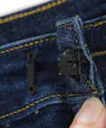 Close-up of Heavy Duty Black Pant Hook And Eye Quick Fix Sewing Kit Set on waistband of denim trousers for secure fastening.