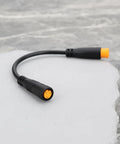 Close-up of black 3-pin waterproof sensor cable for e-bikes, male to female connectors. Product: Two Pack 3 Pin Electric Bicycle Sensor Cables Waterproof Male To Female Connectors For E Bikes Upgrade And Maintenance Compatible With Throttle Sensors Gear Sensors Thumb Throttles Rotary Throttles Brake Levers And Hydraulic Brake Sensors.