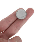10 Pack Stainless Steel Round Knockout Seal Caps For Electrical Breaker Panels held in hand, showcasing a heavy duty weatherproof plug.