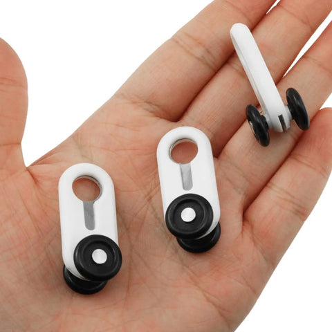 Dead Silent Double Wheel Curtain Track Rollers 30 Pack With Smooth Gliding Pulleys held in a hand, showcasing design and material.