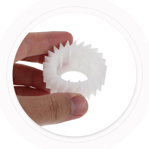 Hand holding Washer Plastic Ratchet Clutch Replacement Part With Precise Torque Control, Heavy-Duty Gear For Easy Installation And Reliable Home Use, Durable Plastic Construction For Long-Lasting Laundry