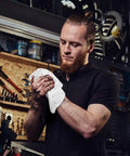 Person using Pro Grade Auto Shop Towels 100 Pack Lint Free 14x14 Bulk Rags Made From 100 Percent Cotton in workshop