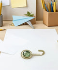 Pack Of 4 Self Adhesive Wall Hooks Featuring A Vintage Diamond Design on a desk among paper and stationery.
