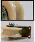 Badass Heavy Duty Nylon Groove Caster Wheel With Dual Bearings close-up of nylon wheel and metal bracket for sliding doors and gates.