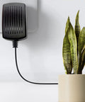 Genuine 12V AC DC Replacement Wall Charger For Makerbot 3D Scanner Mp03955 plugged into the wall next to a plant.