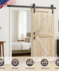Twenty By Eighty Four Inch Unfinished Spruce Barn Door With Modern British Brace Design, showcased in a living room.