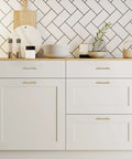 Top Shelf Champagne Bronze Kitchen Cabinet Handles Three Quarter Inch Center Six Inch Long Five Pack heavy duty stainless steel pulls on white cabinets.