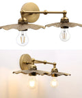 Two Light Industrial Metal Wall Sconces With Antique Brass Flower Ripple Shade, mounted on wall, bulbs visible, retro farmhouse lighting.