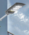 Kick Back With Top Tier Solar Floodlight Featuring Radar Motion Sensor And Handy Remote Control Dusk To Dawn Light Control mounted on a wall.