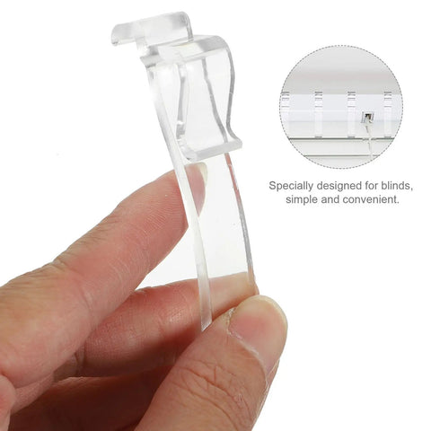 Thirty Piece Set Of Transparent Valance Clips For Window Blinds 2.5 Inch hidden track holder in hand, clear durable plastic design.