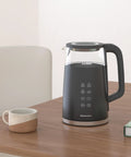 Black 1.7L Dual Wall Electric Tea Kettle With Cool Touch Borosilicate Glass, 304 Stainless Steel Interior on table, digital touchscreen visible