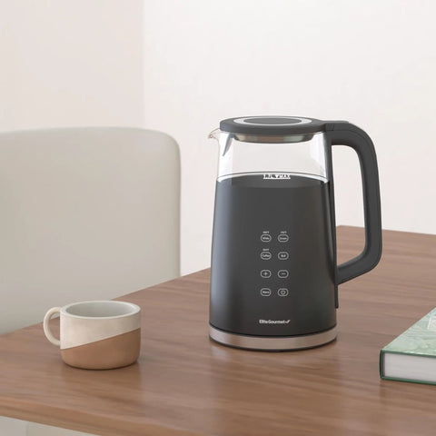 Black 1.7L Dual Wall Electric Tea Kettle With Cool Touch Borosilicate Glass, 304 Stainless Steel Interior on table, digital touchscreen visible