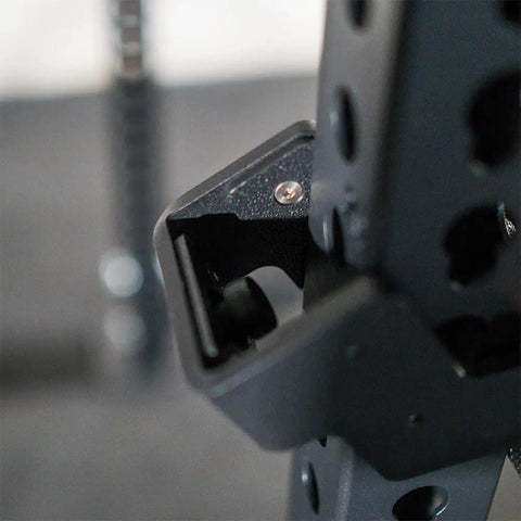 Close-up of Hardcore Power Rack Safety Straps Rated Five Thousand Pound with bounce free catch tech mounted on rack.