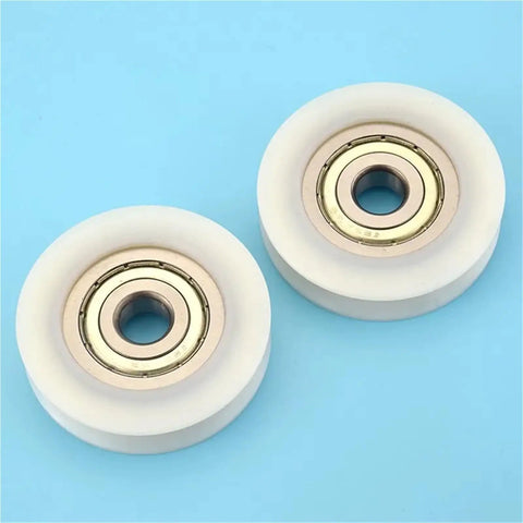 10 Pack U Groove Nylon Pulley Wheels Featuring Self Lubricating Plastic Coated Bearings That Resist Rust And Reduce Friction For Hassle Free Heavy Duty Tracking Projects, two wheels with gold bearings.