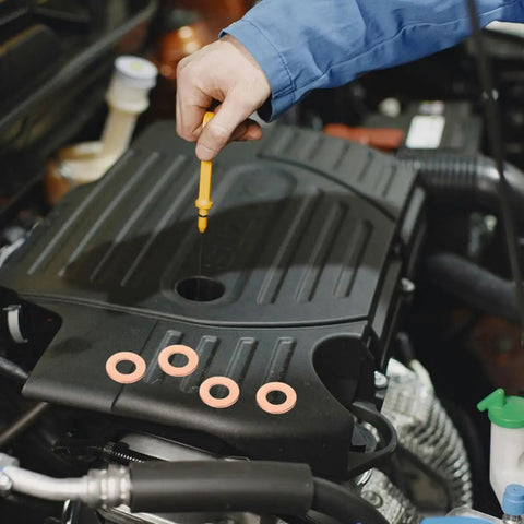 Mechanic using dipstick near 200 Piece Copper Sealing Washers And Flat Ring Gasket Set For Automotive Sheet Metal Repair DIY