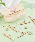 Six Durable Alloy Turn Lock Clasps With Matching Washers And Nuts For Easy Install Crafty Makers Trust This Solid Bang Buck Hardware For Diy Wallets Fly Purses And Pro Handbag Builds with a light gold finish on a green surface.