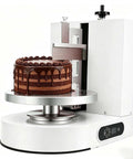 Automatic Cake Icing Spreading Machine With 200W Copper Motor Bidirectional Spin LCD Touch Panel Frost Cakes 4 To 12 Inches Like A Pro Pro Grade Decorating Tool For Home Bakers And Shops Even Frosting Every Time shown frosting chocolate cake.