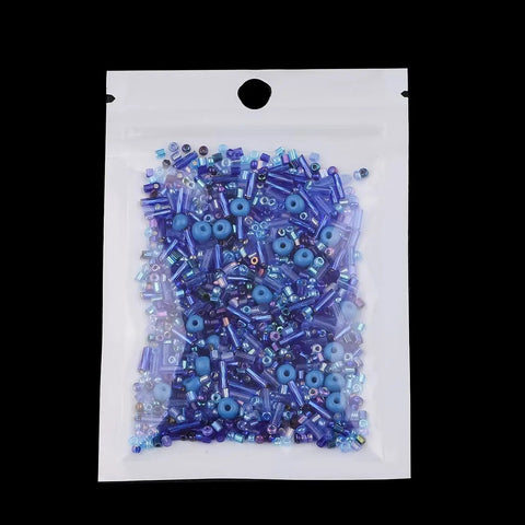 Top Shelf 800 Piece Assorted Black Glass Seed Beads With Multi Shape Spacer Mix Designed For Hustle Free Handmade Jewelry Crafting Creative Kits Wedding Accents And Prime Fashion Upgrades in a clear bag with assorted blue beads.