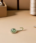 Slick Four Pack Adhesive Wall Hooks For Hanging Towels And Robes With Knockout Grip No Drilling Required Super Quick Mount For Bathroom Kitchen Or Entryway Storage on a beige surface.
