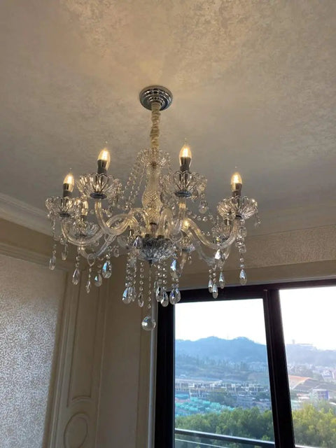 Modern Crystal Ceiling Pendant Light With Polished Chrome Frame And E14 Bulb Socket For Killer Kitchen Island Ambiance Or Cozy Living Room Glow That Truly Slaps Vibe Upward hanging from the ceiling with crystal accents.