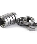 Smooth As Butter 10Pcs 10X15X4MM Double Shielded 6700ZZ Thin Bearings displayed in a stack and scattered, made of steel.