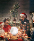 Family enjoying Christmas dinner with Levitating Moon Lamp With Floating And Spinning Moon Led 3D Printed Surface centerpiece.