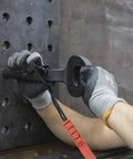 Worker using the Workhorse Construction Spud Wrench With Tether Hole Made In USA 1-1/4 Inch Opening for bolt alignment on steel frame.