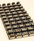 Essential M5 Cage Nuts And Rack Screws For Server Cabinets And Equipment Racks showing a close-up view of multiple nuts in a row.