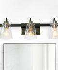 Three Light Vanity Fixture With Seeded Glass Diffusers Matte Black Finish With Polished Nickel Accents Sleek Industrial Vibe