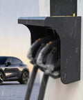 Heavy Duty Outdoor EV Charger Cover protects charging cables from rain while mounted on a wall near a parked vehicle.