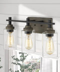 Farmhouse 3 Light Vanity Lighting Fixture In Bronze And Matte Black With Clear Cylinder Glass Over Mirror 21 Inch Bathroom Light Bar
