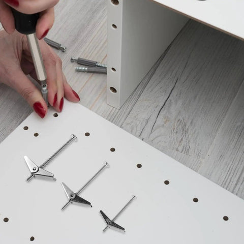 Person installing Seriously Tough Drywall Toggle Bolts And Wing Nuts Kit 24 Pieces Galvanized Iron Set, wood background.