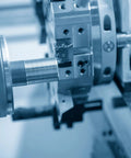 Side view of a stainless steel M10 x 400mm fully threaded rod being machined in a lathe.