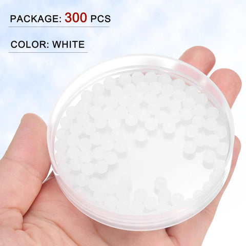 Three Hundred White Polypropylene Plastic Precision Bearing Balls 5mm Diameter G2 Grade Frosted Finish in a hand-held clear container.