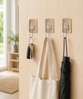 Six Pack Tough Grip Adhesive Wall Hooks Offering No Sweat No Drill Install Slick Gold Square Plate And Clear Hooks hanging keys and a tote.