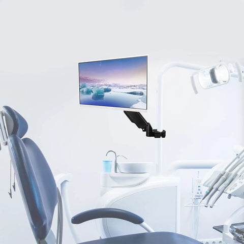 Smooth Operator Pneumatic Pole Mount Arm For 17 To 32 Inch Monitors mounted in a dental office for flexible screen positioning.