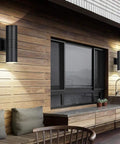 Dusk To Dawn Outdoor Wall Light With Up And Down Lighting, LED A19 Bulbs Included, featured on a wooden porch wall, matte black finish.