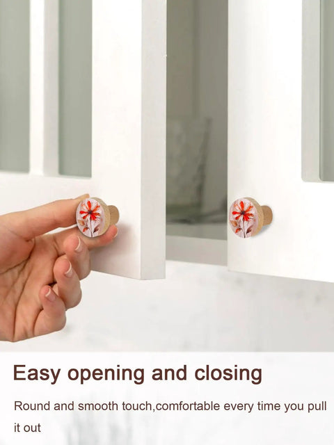 Close-up of Kickass Red Floral Wooden Cabinet Knobs Solid Beech Drawer Handles on a white cabinet, demonstrating easy opening.
